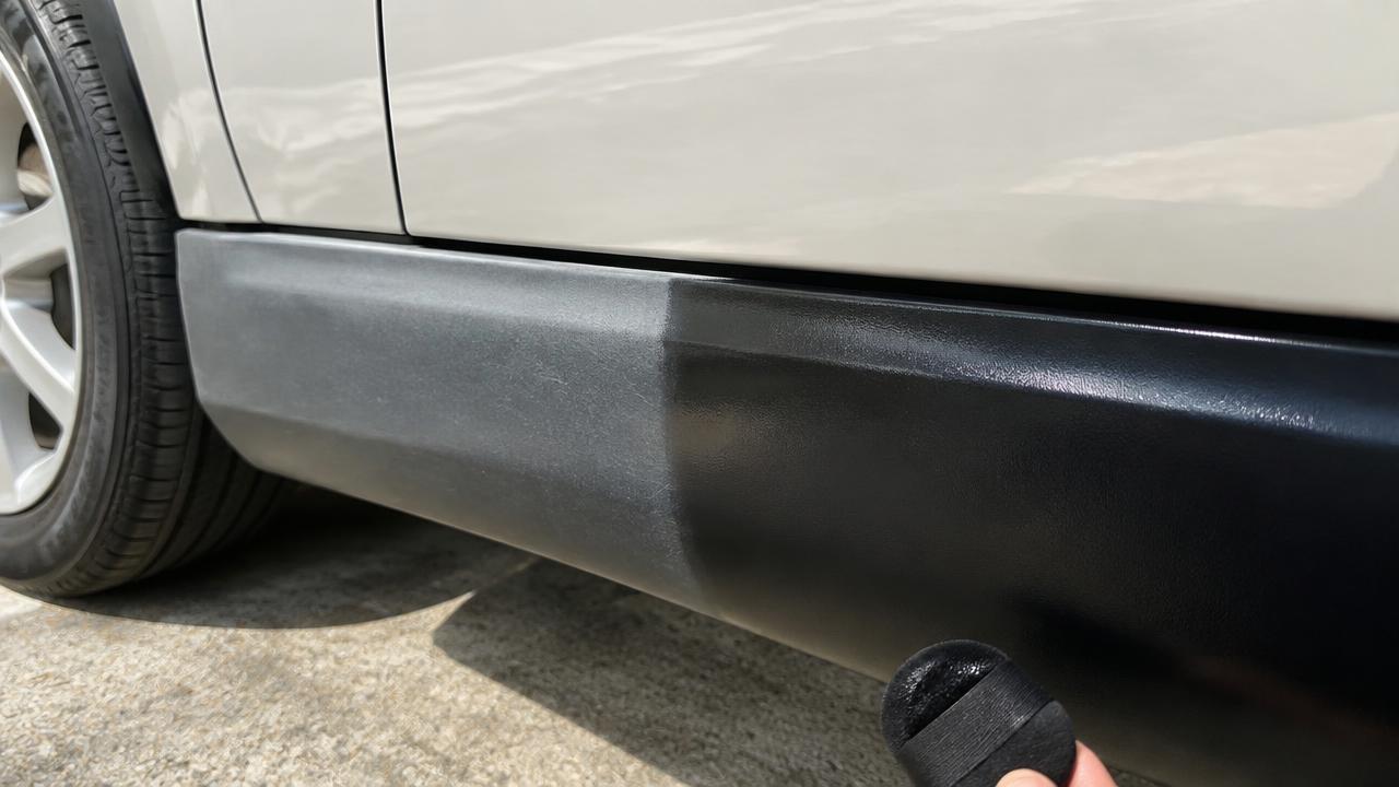 Faded black car trim half restored to deep black with dressing